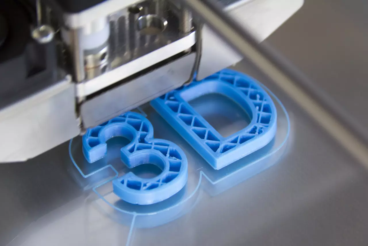 The characters "3D" 3d-printed in blue