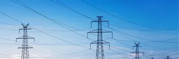 Landscape of power lines over a blue sky at sunrise or sunset