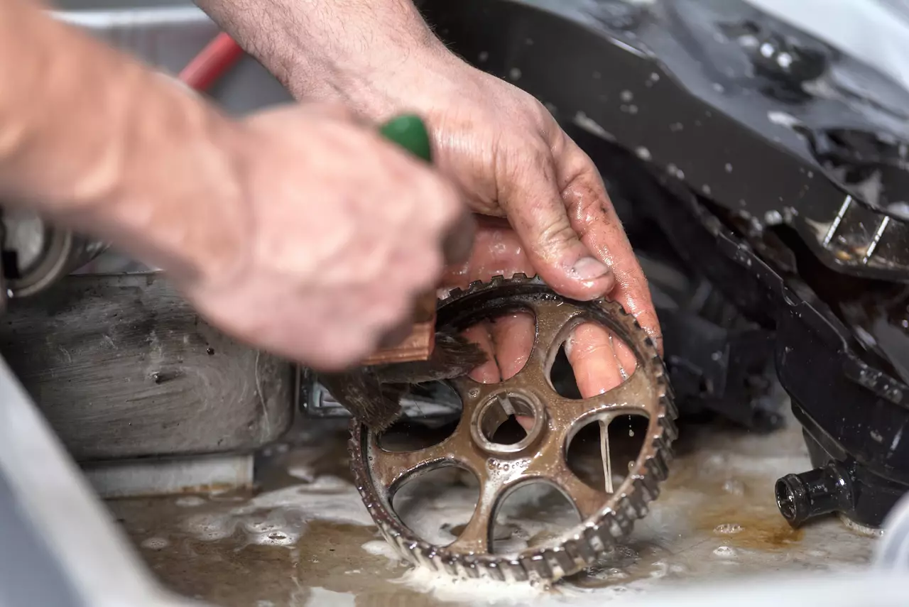 Person cleaning metal parts